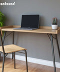 Peel And Stick Baseboard Trim With Self Adhesive Chair Rail Molding Made From Hardened Rubber, shown under desk with chair