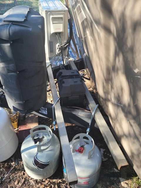 Propane tanks and metal support frame near truck with four pack three and a half inch by twelve inch square bend U bolt kit setup.