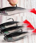 Five Piece Soft Plastic Fishing Lure Set, 8Cm T Tail Bait with 3D Eyes and sharp treble hooks on wooden surface.
