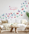 Black Girl Magic Wall Decals You Are Beautiful Inspirational Stickers with Afro Butterfly Design on living room wall with sofa