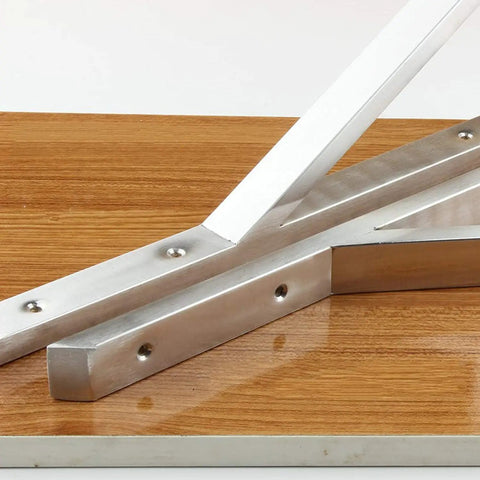 Heavy Duty Stainless Steel Triangle Shelf Brackets Pack Of Two Built Like A Tank resting on wood surface for corner supports.