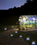 Greenhouse at night with 12 Pack Outdoor Solar Lights Waterproof Landscape Pathway Garden Lights illuminating the walkway