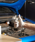 Hand holding Tire Changer Spare Parts Alloy Double Hinge Connector Replacement Screws, car engine in background