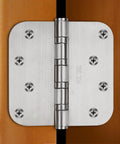 4-inch 304 stainless steel ball-bearing door hinge installed on wood door; brushed finish with visible screws.