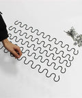 Heavy Duty Compression Spring Repair Kit With Screws Included, shown with wavy springs and fastening screws on white surface
