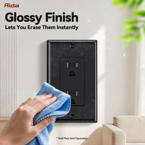 Person cleaning a Slick Glossy Black Decorator Wall Outlet with a cloth in a bright living space.