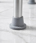 Close-up of Grippy Anti Slip Rubber Feet For Shower Chairs And Tub Transfer Benches In Wet Bathrooms 4 Pack on wet surface