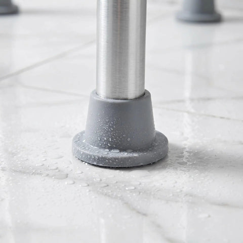 Close-up of Grippy Anti Slip Rubber Feet For Shower Chairs And Tub Transfer Benches In Wet Bathrooms 4 Pack on wet surface