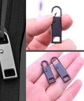 Close-up of 12 Pack Zipper Pull Tabs Replacement Set Upgraded Easy Fix Detachable Zipper Pulls In Black And Silver Two Sizes 36mm And 30mm For Luggage Jackets Backpacks Boots Purses Coats Durable Zinc Alloy, featuring pulls held in hand.