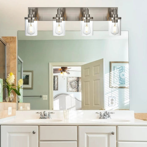 Four Light Vanity Light In Brushed Nickel With Clear Glass Shades, E26 Base, over bathroom mirror