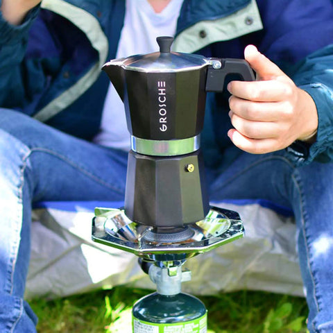 Bold Black Nine Cup Stovetop Espresso Maker Moka Pot on portable stove for outdoor coffee brewing.
