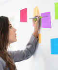 Woman using Nine Pack 4x6 Inch Lined Sticky Notes With Lines In Nine Bright Colors Large Ruled Self Adhesive Note Pads on wall