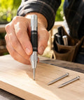 5 Inch Automatic Center Punch With 2 Spare Tips Adjustable Tension Spring Steel Marking Tool in use on wood with nails.