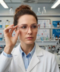 Kickass 4 Pack Clear Safety Glasses With Anti Fog Lens Guard Scratch Resistant Build And Full Wrap Side Shields For Nurses Lab Techs And Outdoor Enthusiasts worn by a lab technician adjusting eyewear in a laboratory.