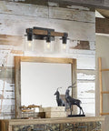 4-Light Industrial Farmhouse Vanity Lights with Rustic Wood and Clear Glass above rustic mirror in cozy home.