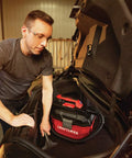 Person using Cordless Shop Vac Vacuum Cleaner Wet And Dry 2 Gallon Tank With 7 Foot Hose Bare Tool Only in car trunk
