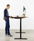 A man using Under Desk Pullout Drawer 18 Inch Slide Out Storage Organizer For Home Office Black Keeps Clutter Down And Workflow Smooth With Easy Access Desk Hack DESKAC03B under a standing desk.