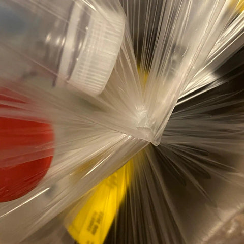 33 Gallon Clear Trash Liners, Heavy Duty High Density Garbage Bags holding recyclable items, 33 by 40 inches, leak proof and tear resistant