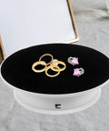 Sleek Electric Rotatable Jewelry Display Stand Turntable With Ultra Smooth Two Speed Rotation And High Capacity Bearing showcasing gold and silver rings.