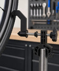 Slick Portable Bike Wheel Truing Stand, Precision Spoke Adjuster for MTB and Road Cycles, close-up of wheel clamp detail.