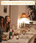 12 Pack Mini Lanterns With Flickering LED Candles on a dining table centerpiece with friends, cozy retro rustic decor for parties.