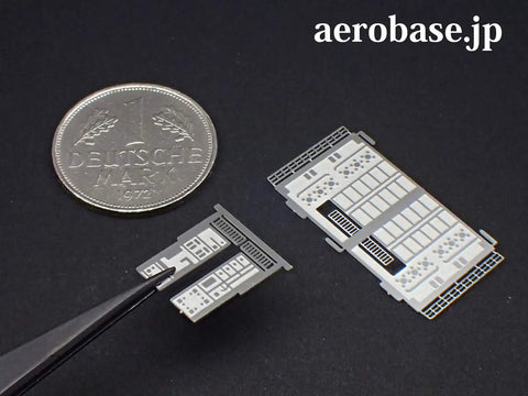 Close-up of photo-etched parts from Hindenburg LZ129 1 to 1000 Scale Photo Etched Stainless Steel Model Kit near coin for scale