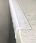 Close-up of silicone edge protector on wood table corner, Chew Proof Silicone Edge Protector For Baby Proofing Furniture, BPA free.