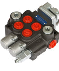 Front view of a two-spool hydraulic directional control valve manifold with red port caps and SAE fittings.