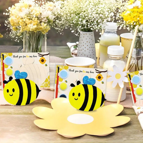 Bee Birthday Party Decor Kit With 24 Wooden Bee Craft Kits To Paint For Party Favors And Bee Themed Gifts Includes Paints Brushes And Thank You Cards Totally Fun For Honey Baby Shower Decorations And Creative Diy Party Activities with thank you cards, paints and flower centerpieces on a table.