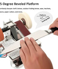 Mini Belt Sander And Electric Knife Sharpener Featuring A Snappy 15 Degree Bevel Plus 90 Angle Stand For Quick Wood Metal Leather Touch Ups Built Tough As Nails For Zero Shake And Super Quiet Run At 3900 Rpm Plugs Straight Into Any Wall Socket, showcasing knife sharpening on a 15-degree beveled platform.
