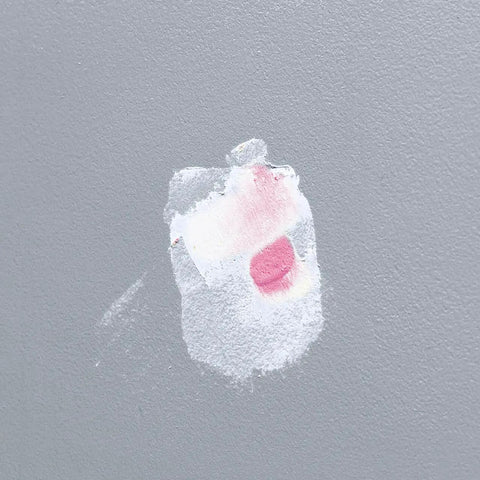 Wall showing Spackling Compound That Goes On Pink And Dries White No Priming Will Not Sink Or Shrink Quick Dry Time Indicator