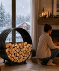 32 Inch Firewood Hoop Rack With Rustproof Cover beside fireplace, woman tending fire, holds 500 lbs, all-weather protection indoors