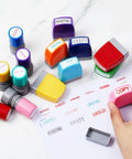 Top Shelf Fourteen Piece Self Inking Office Stamp Set Featuring Slick Business Message Designs For Approved Paid Copy Faxed And Scanned Papers That Make Desk Work Go With Zero Sweat, showcasing colorful stamps on a desk.
