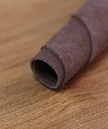 Close-up of rolled brown cowhide leather, highlighting material for Leather Welding Work Apron With Heat And Flame Resistant Cowhide.