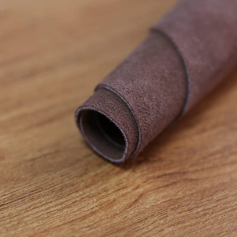 Close-up of rolled brown cowhide leather, highlighting material for Leather Welding Work Apron With Heat And Flame Resistant Cowhide.
