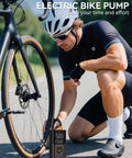 Man using Portable Tire Inflator With Gauge And USB Charging Output, 150 PSI Fast Air Compressor For Cars, Bikes, Motorcycles, Scooters And Balls, Quick Inflate On The Go with bicycle.