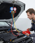 Technician using 4.2 Cfm Pneumatic Vacuum Pump Air Operated Evacuation Tool For Automotive Air Conditioner Systems on car engine.