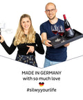 Two people holding magnetic dinnerware products, including a bottle tray and plates, with text "Made in Germany."