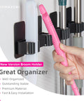 4 Pack Wall Mount Broom And Mop Holder Set With Ultra Anti Slip Grippers For Kitchen, Bathroom, Closet, Garden And Garage No Drilling Needed Space Saving Organizer Black, showing multiple tools held securely.