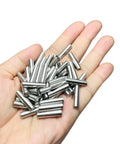 Hand holding 52-Piece 5mm x 20mm Dowel Pins Stainless Steel 304 Shelf Pegs for Wood Furniture and Beds M5 Pins