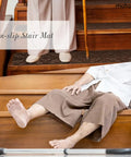 Non Slip Carpet Stair Treads For Wooden Steps Self Adhesive 8x30 Inches 15 Pack Black Peel And Stick Rug Runners For Dogs Kids And Elderly Home Safety shown on wooden stairs with a person standing and sitting for safety demonstration.