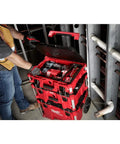 Worker using Packout 22 Inch Tool Box With Heavy Duty Latches And Interior Organizer Trays Durable Modular Storage System For Tools