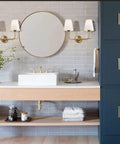 Two Light Wall Sconce With White Fabric Tapered Shades In Dope Antique Brass Finish for a bathroom vanity setting, dimmable LED.