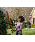 Woman using Heavy Duty 26 Inch Brushless Hedge Trimmer Built Tough To Slice Through Nasty Brush Like Butter in yard.