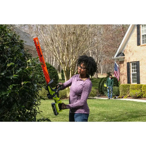 Woman using Heavy Duty 26 Inch Brushless Hedge Trimmer Built Tough To Slice Through Nasty Brush Like Butter in yard.