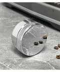 Prime Pick 58Mm Espresso Coffee Distributor And Adjustable Palm Tamper Stainless Steel core resting on a marble surface with coffee beans.