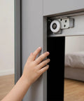 Heavy Duty Sliding Door Wheels For Cabinets And Closets 2 Pack Adjustable Iron Rollers close-up on roller with hand on cabinet.