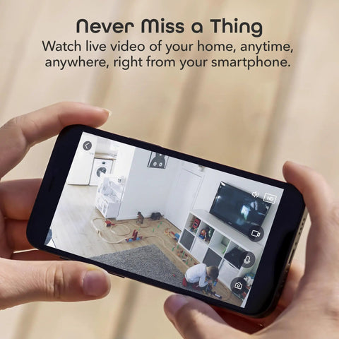 Person viewing live feed from 1080P Indoor Security Camera With WiFi on smartphone, showing room and child playing.