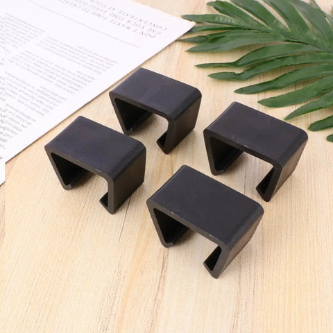 Four Pack Plastic Sectional Sofa Clips For Rattan Furniture on a wooden surface