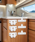Super Secure 4 Pack White Marine Boat Ball Catch Roller Latch Spring Back Plates For Cabinet Doors And Cupboards Durable Plastic Hardware That Fits Anywhere mounted on a wooden cabinet.